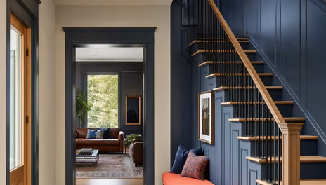 Long hallway with a continuous run of baseboard and panel trim