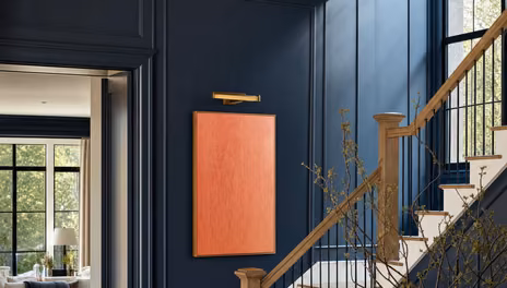 Painted panelling beside stained hardwood door casing